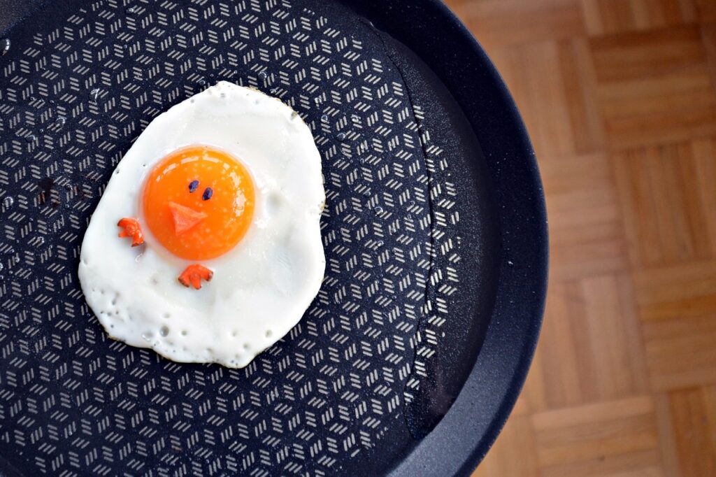 A sunny side up egg. with a happy chick face on it. 